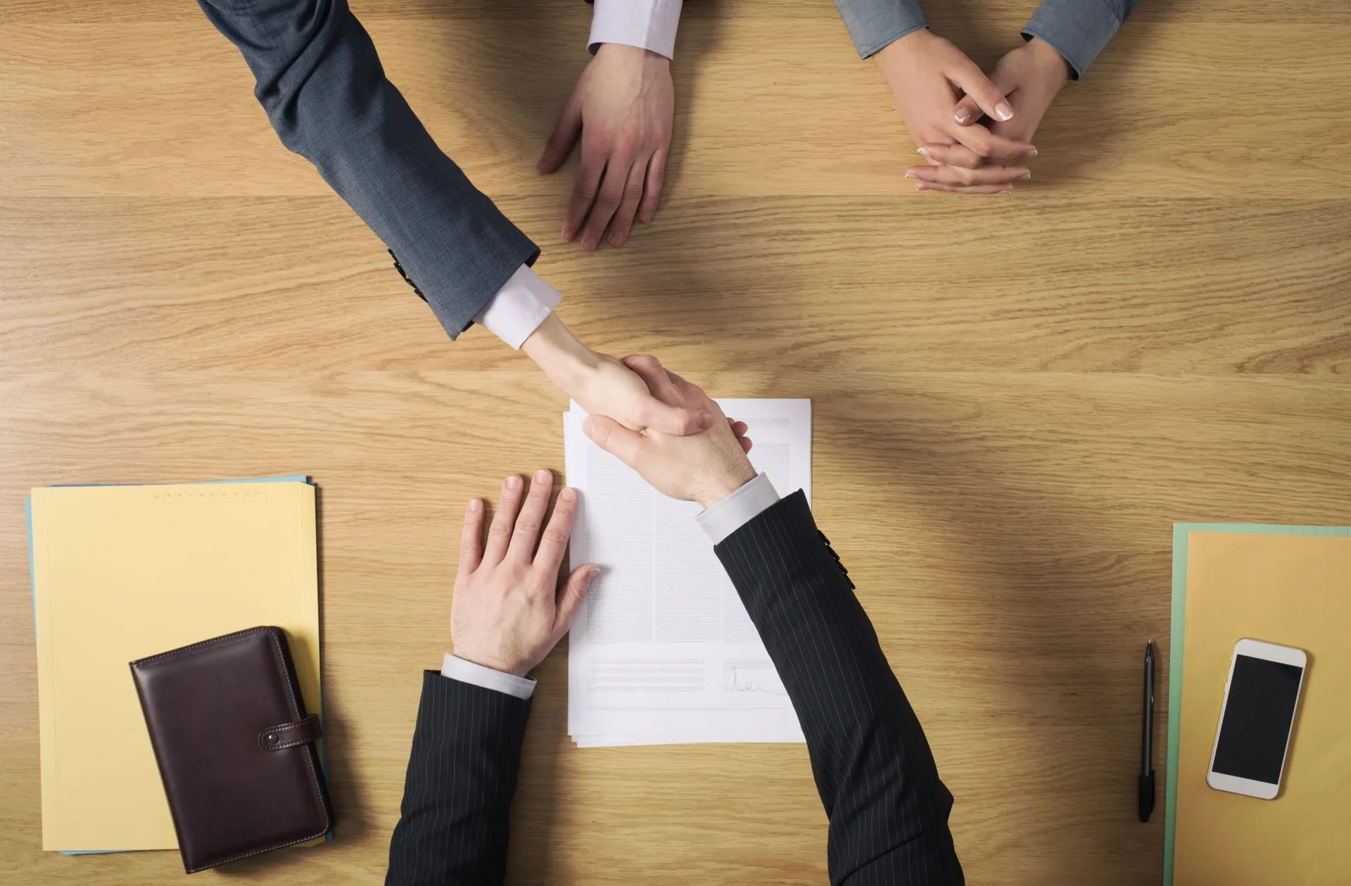 shaking hands across table